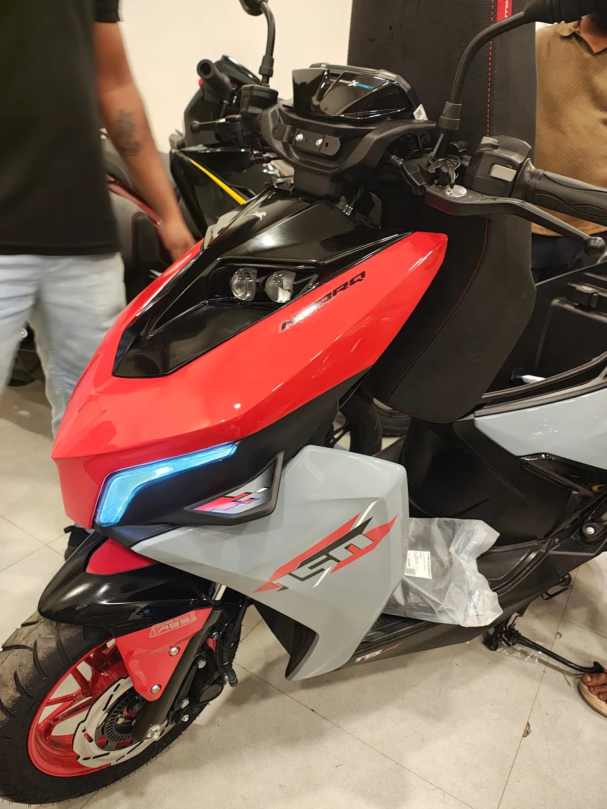 Close-up of our new TVS NTorq 150 rental scooter, showing its LED headlamps, blue light strip and 150 badge