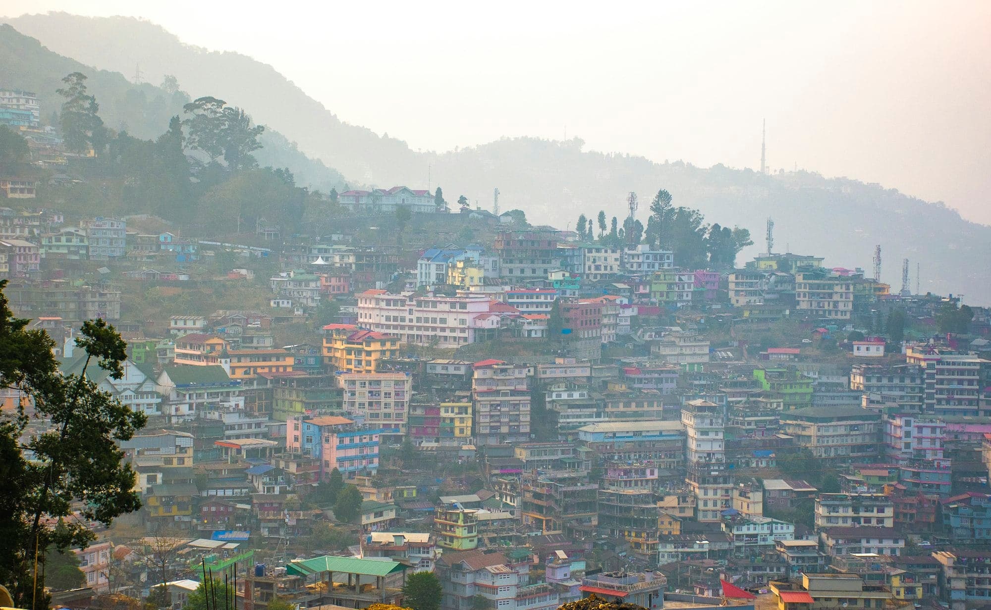 Misty morning over houses stacked on the hillside in Kohima, Nagaland